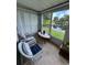 Cozy sun room with ample windows overlooking a tranquil pond at 12104 Boynton Ln, New Port Richey, FL 34654