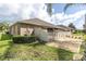 Lush backyard featuring a grassy area, gravel landscaping, and a privacy fence at 13600 Crest Lake Dr, Hudson, FL 34669