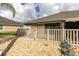 View of backyard, gravel landscaping, patio with privacy fence at 13600 Crest Lake Dr, Hudson, FL 34669