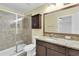 Bathroom featuring a glass shower, granite countertops, and dark wood cabinets at 13600 Crest Lake Dr, Hudson, FL 34669