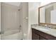 Bathroom featuring a bath tub, granite countertops, and dark wood cabinets at 13600 Crest Lake Dr, Hudson, FL 34669