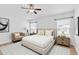 Comfortable bedroom with natural light from the two large windows, carpet and ceiling fan at 13600 Crest Lake Dr, Hudson, FL 34669