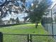 Dog park with green grass, mature trees, benches, and a fenced-in area at 13600 Crest Lake Dr, Hudson, FL 34669