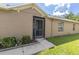 Home's exterior shows a screened entry and manicured landscaping at 13600 Crest Lake Dr, Hudson, FL 34669