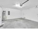 Spacious garage with ample storage, including a water heater and electrical panel at 13600 Crest Lake Dr, Hudson, FL 34669