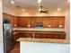 Modern kitchen with granite countertops, stainless steel appliances, and wood cabinets at 13600 Crest Lake Dr, Hudson, FL 34669