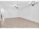 Bright living room featuring tile flooring, ceiling fan and abundant natural light throughout at 13600 Crest Lake Dr, Hudson, FL 34669