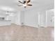 Bright living room featuring tile flooring, ceiling fan and abundant natural light throughout at 13600 Crest Lake Dr, Hudson, FL 34669