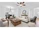 Bright, airy living room featuring stylish decor, ample seating, and an open layout perfect for modern living at 13600 Crest Lake Dr, Hudson, FL 34669