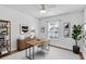 Bright home office with wood floors, modern desk, a bookcase, and ample natural light at 13600 Crest Lake Dr, Hudson, FL 34669