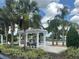 Inviting community pool with pergolas, palm trees, and lounge chairs, perfect for relaxation at 13600 Crest Lake Dr, Hudson, FL 34669