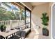 Outdoor porch featuring plants, seating, and a palm tree view at 13600 Crest Lake Dr, Hudson, FL 34669