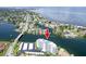 An aerial view of a white condominium building with waterfront views, community, and a bridge at 1365 Snell Isle Ne Blvd # 1B, St Petersburg, FL 33704