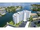 An aerial view of a white condominium building with waterfront views and a parking lot at 1365 Snell Isle Ne Blvd # 1B, St Petersburg, FL 33704