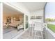 Balcony with patio furniture looking to interior living area with a floral wall painting at 1365 Snell Isle Ne Blvd # 1B, St Petersburg, FL 33704