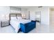 A bedroom with a blue chaise lounge at the foot of the bed at 1365 Snell Isle Ne Blvd # 1B, St Petersburg, FL 33704
