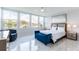 Bright bedroom with a water view, large windows and a blue chaise lounge at 1365 Snell Isle Ne Blvd # 1B, St Petersburg, FL 33704