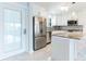 Bright kitchen with white cabinets, stainless steel appliances, and a granite countertop island with barstool seating at 1365 Snell Isle Ne Blvd # 1B, St Petersburg, FL 33704