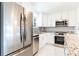 Bright kitchen with stainless steel appliances, white cabinets, and a stylish backsplash for a clean design at 1365 Snell Isle Ne Blvd # 1B, St Petersburg, FL 33704