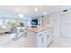 Open concept living space featuring kitchen island with marble countertops and new appliances at 1365 Snell Isle Ne Blvd # 1B, St Petersburg, FL 33704