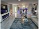 Bright living room next to the kitchen and dining area, features white marble floors and an entertainment center at 1365 Snell Isle Ne Blvd # 1B, St Petersburg, FL 33704