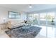 Inviting living room with water views, sliding glass doors to balcony, and a comfortable white sofa at 1365 Snell Isle Ne Blvd # 1B, St Petersburg, FL 33704