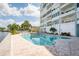 Enjoy the sunny outdoor community pool with comfortable lounge chairs and lush landscaping at 1365 Snell Isle Ne Blvd # 1B, St Petersburg, FL 33704