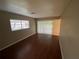 Bedroom features laminate wood floor, neutral walls, window and access to the enclosed patio at 1392 Piper Rd, Spring Hill, FL 34606