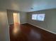 This bedroom features hardwood floors and a window providing natural light at 1392 Piper Rd, Spring Hill, FL 34606