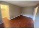 A cozy bedroom featuring hardwood floors and a closet for ample storage at 1392 Piper Rd, Spring Hill, FL 34606