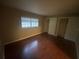 Bedroom featuring a window providing natural light and closet with bi-fold doors at 1392 Piper Rd, Spring Hill, FL 34606