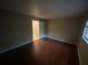 Bedroom with hardwood floors, a window for natural light, and neutral paint at 1392 Piper Rd, Spring Hill, FL 34606
