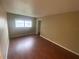 A bright bedroom boasts hardwood floors and a closet for ample storage at 1392 Piper Rd, Spring Hill, FL 34606