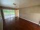 Bedroom featuring laminate wood floor, neutral walls, and door to the patio at 1392 Piper Rd, Spring Hill, FL 34606