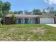 Charming single story home featuring a brick facade, 2-car garage and a well-manicured lawn at 1392 Piper Rd, Spring Hill, FL 34606