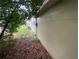 Exterior side view of the house with a small yard area at 1392 Piper Rd, Spring Hill, FL 34606