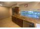 Spacious kitchen showcasing granite countertops, tile backsplash, stainless steel appliances and great backyard view at 1392 Piper Rd, Spring Hill, FL 34606