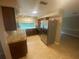 Bright kitchen showcasing stainless steel appliances, granite counters and view from the pass-through to the living room at 1392 Piper Rd, Spring Hill, FL 34606