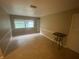 Well-lit living room with neutral colored walls, white trim and neutral tile flooring at 1392 Piper Rd, Spring Hill, FL 34606