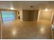Open living room with tile floors, and sliding glass doors that lead to an enclosed patio at 1392 Piper Rd, Spring Hill, FL 34606