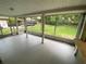 The screened porch offers an outdoor view of the grassy lawn and backyard at 1392 Piper Rd, Spring Hill, FL 34606