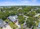 Aerial view of the property showing lush greenery, landscaping, neighborhood, and proximity to the water at 1430 Rosetree Ct, Clearwater, FL 33764