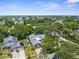 Aerial view showcasing the property's location, surrounding trees, and distance from the coast at 1430 Rosetree Ct, Clearwater, FL 33764