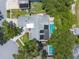Overhead view of the house and pool highlighting the roof's solar panels, trees, and neighborhood at 1430 Rosetree Ct, Clearwater, FL 33764