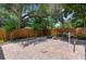 A backyard featuring a brick patio, wooden fence and mature trees for a relaxing outdoor space at 1430 Rosetree Ct, Clearwater, FL 33764