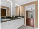 Bright bathroom featuring double vanity, granite countertops, and a view to the outdoor area at 1430 Rosetree Ct, Clearwater, FL 33764