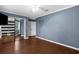 Bedroom with neutral wall color, laminate flooring, and sliding glass door closet at 1430 Rosetree Ct, Clearwater, FL 33764