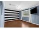 Bedroom with modern flooring, a large window and black and white striped wall at 1430 Rosetree Ct, Clearwater, FL 33764