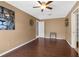 A spacious bedroom features hardwood floors, a ceiling fan and a walk-in closet at 1430 Rosetree Ct, Clearwater, FL 33764