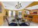 Bright dining room features a glass table, large windows, and access to the outdoor pool area at 1430 Rosetree Ct, Clearwater, FL 33764